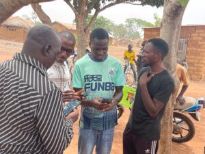 People in a remote village listening to Gospel recordings in their heart language